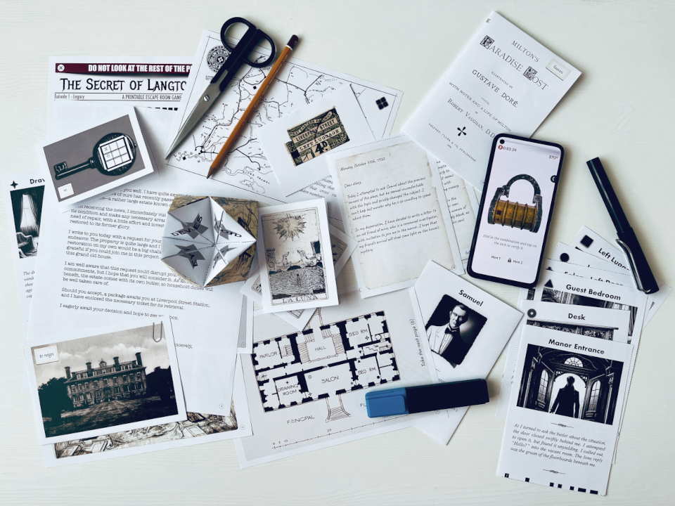 Tabletop setup of the free printable escape room game 'Secret of Langton Manor'. The image shows the physical game materials—including cut-out paper puzzles, an origami fortune teller, and a floor plan—alongside a smartphone running the companion app.
