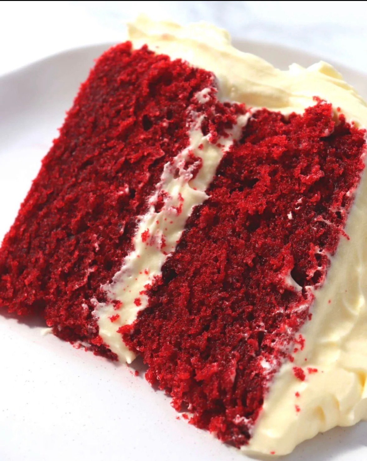 Moist Red Velvet Cake Slice showing fluffy texture and red color.