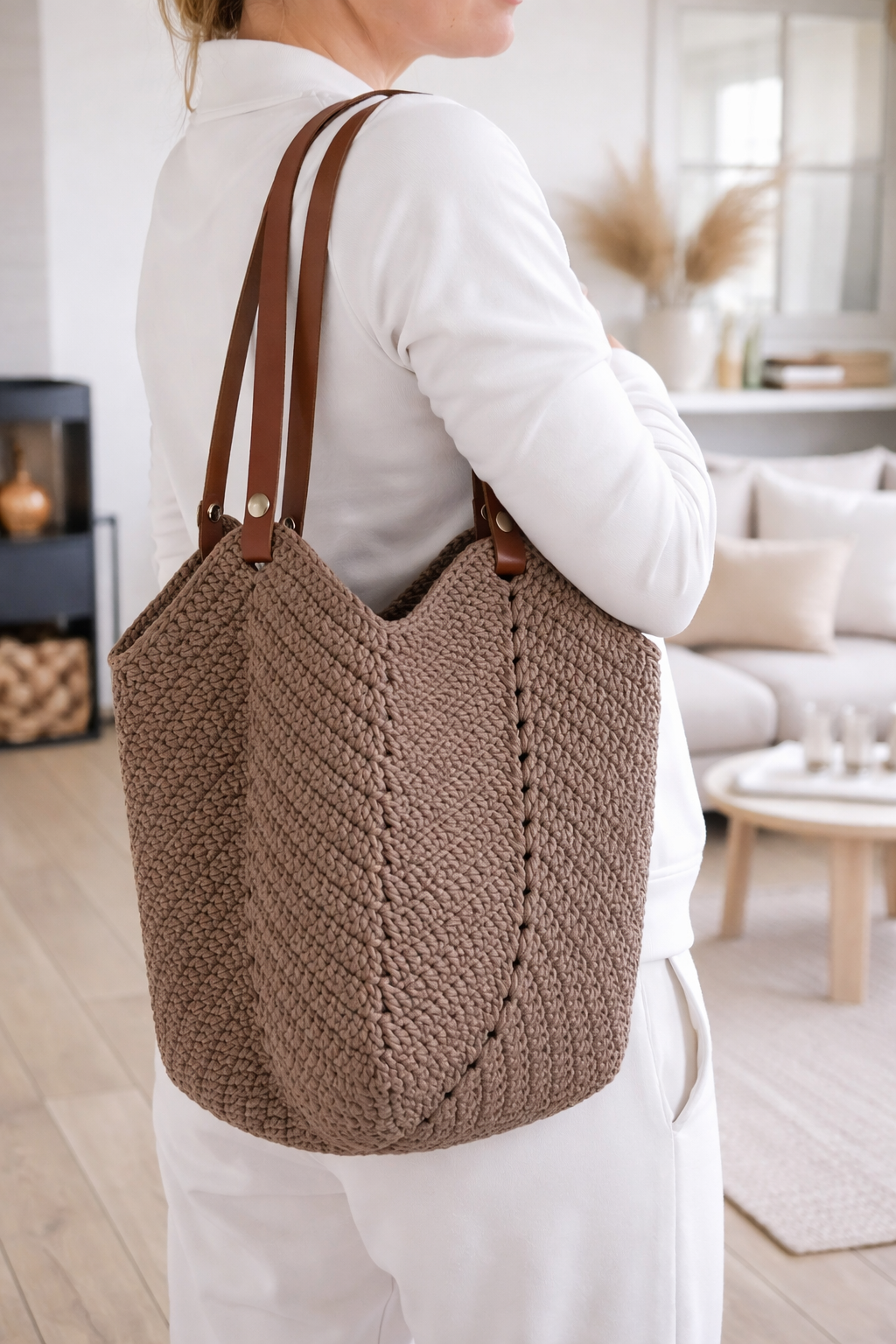 Woman wearing Linnea crochet tote bag on shoulder, handmade minimalist summer bag in city setting