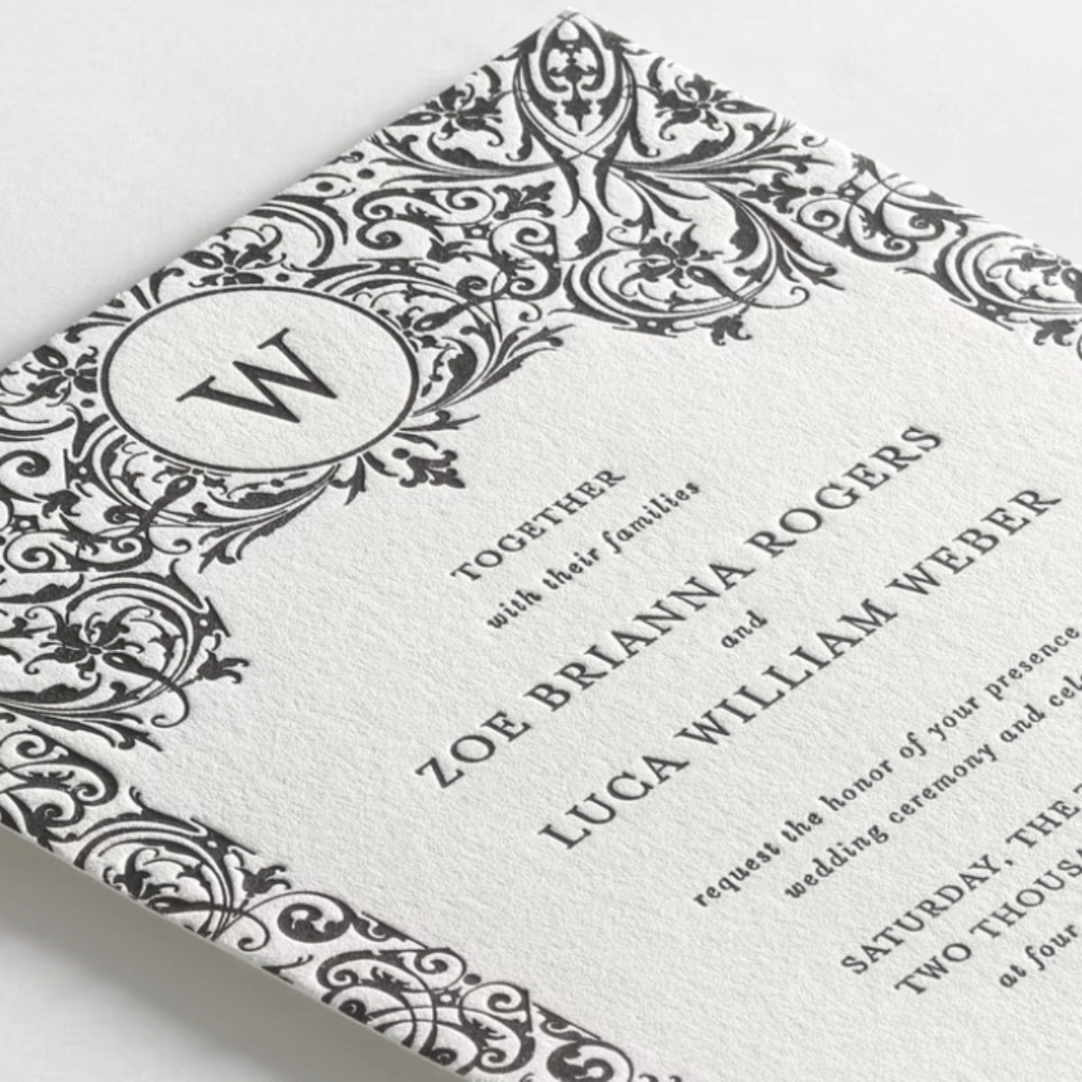 Elegant ready-made wedding invitation featuring deep textural embossing and black filigree scrollwork, curated by SaKredJoi Art. This sophisticated design offers an elevated hand-feel and timeless aesthetic for couples seeking refined, high-end wedding stationery.