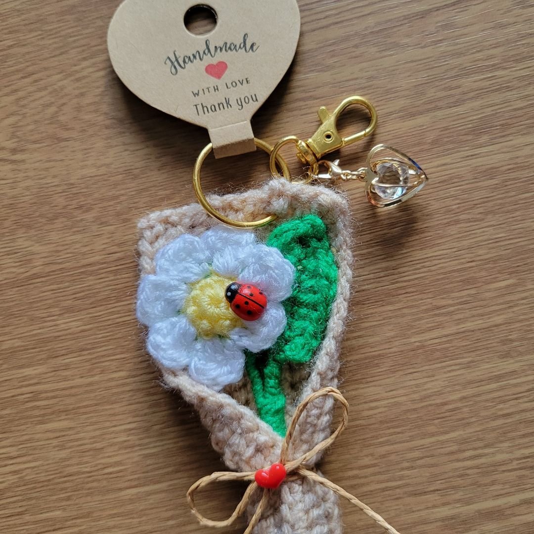 Handmade daisy keychain with gold clasp and decorative heart pendant