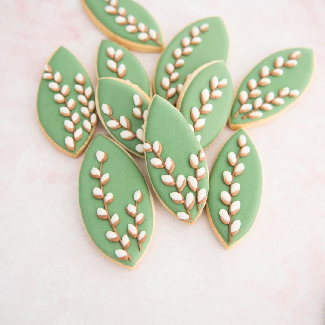 Leaf shaped cookies decorated with pussy willow pattern.