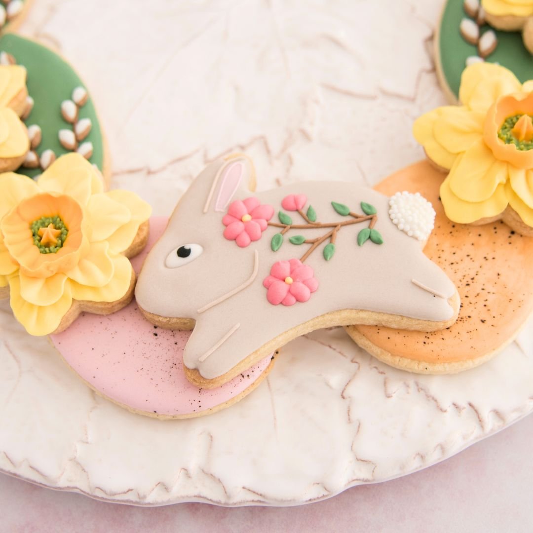 Decorated bunny cookies with light brown and pink flowers.
