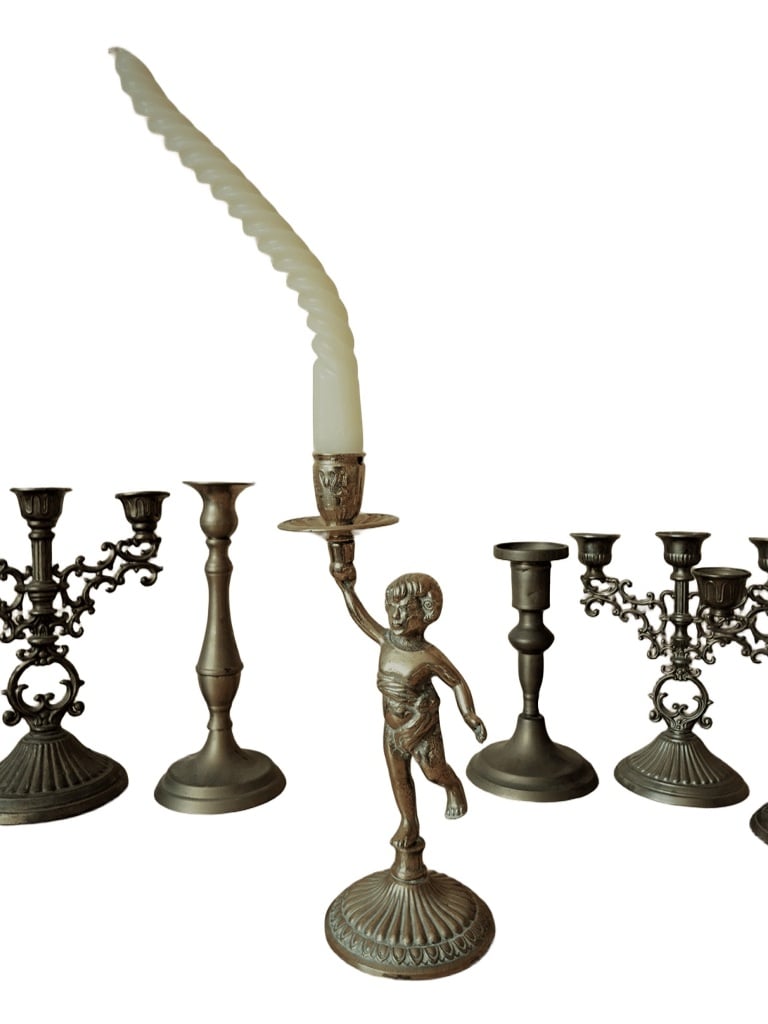 Authentic solid Brass Cherub candle holder. with its original curled Wax candle