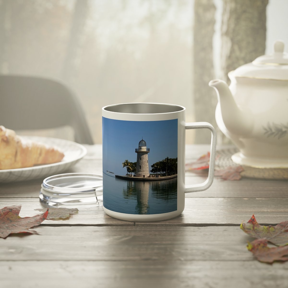 “Front view of insulated stainless steel mug featuring a warm Miami sunrise over the water.”