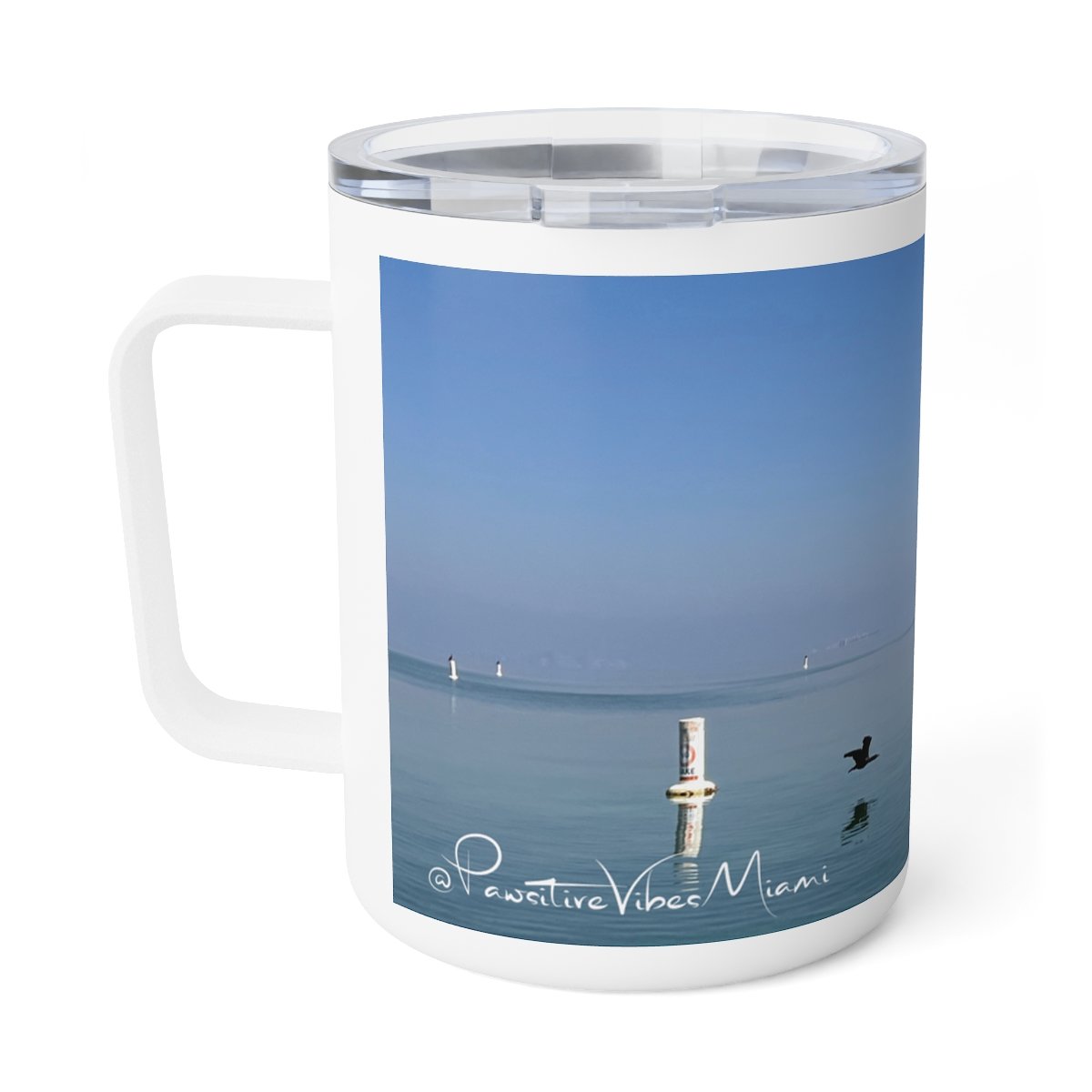 “Front view of insulated stainless steel mug featuring a warm Miami sunrise over the water.”