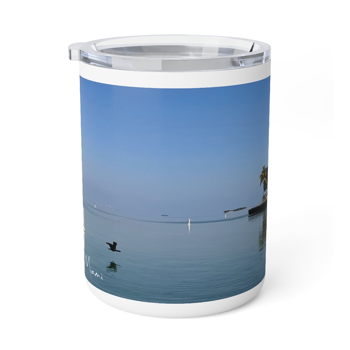 “Front view of insulated stainless steel mug featuring a warm Miami sunrise over the water.”
