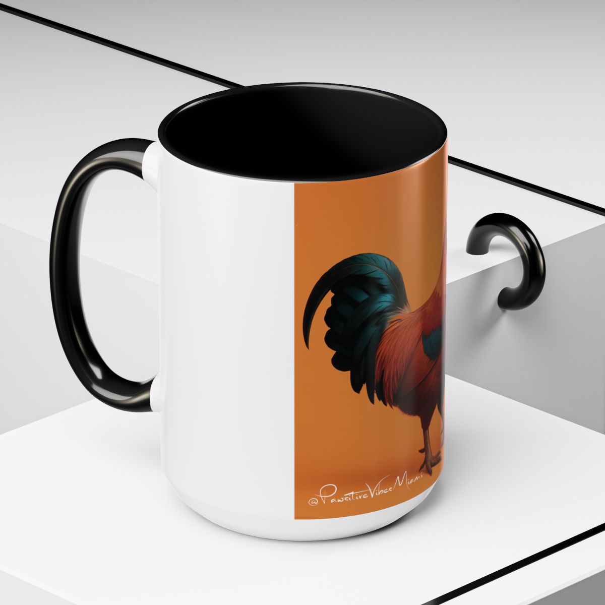 “Angled view of rooster artwork glowing in warm tropical tones on a large mug.”