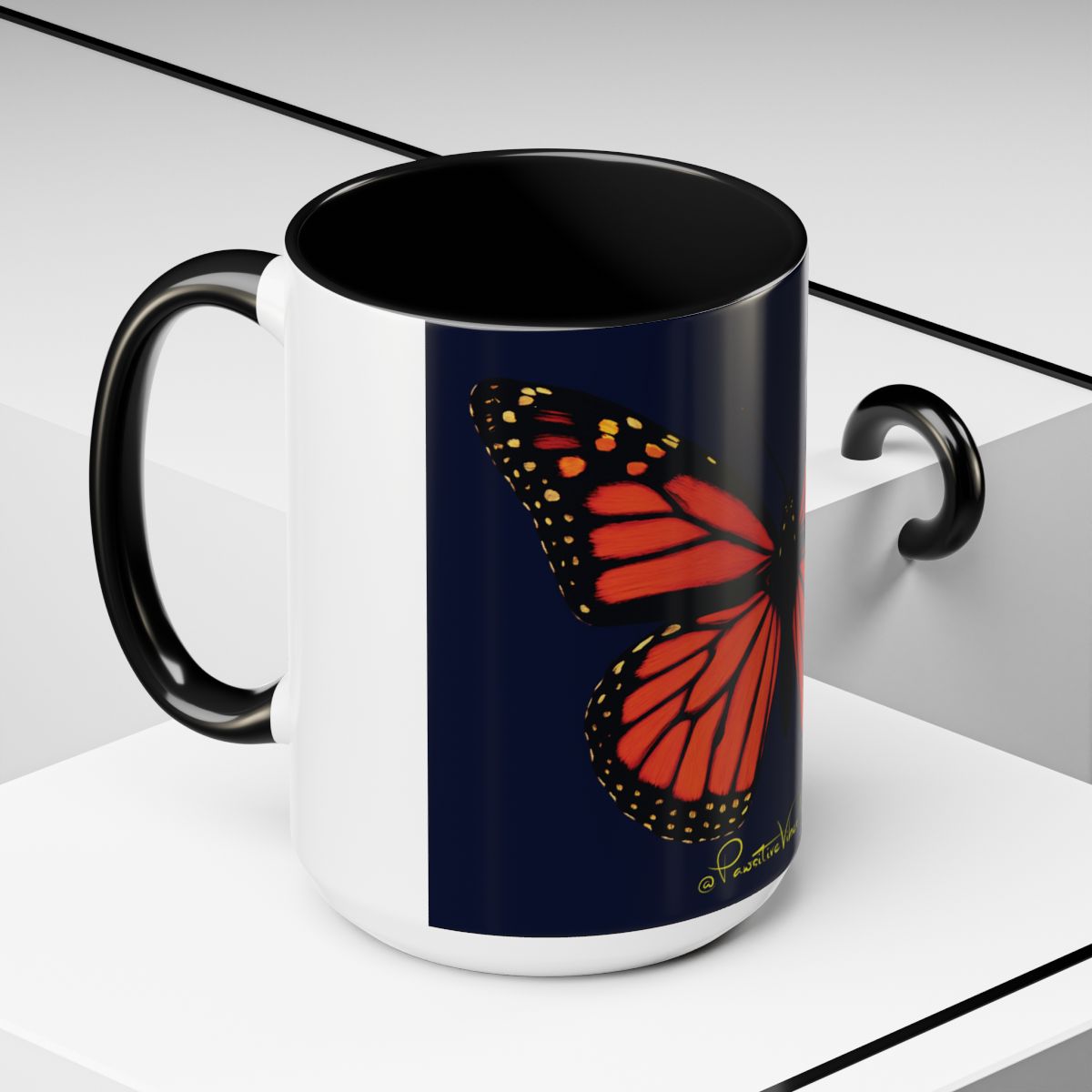 “Close‑up of glowing monarch butterfly illustration printed on ceramic mug.”