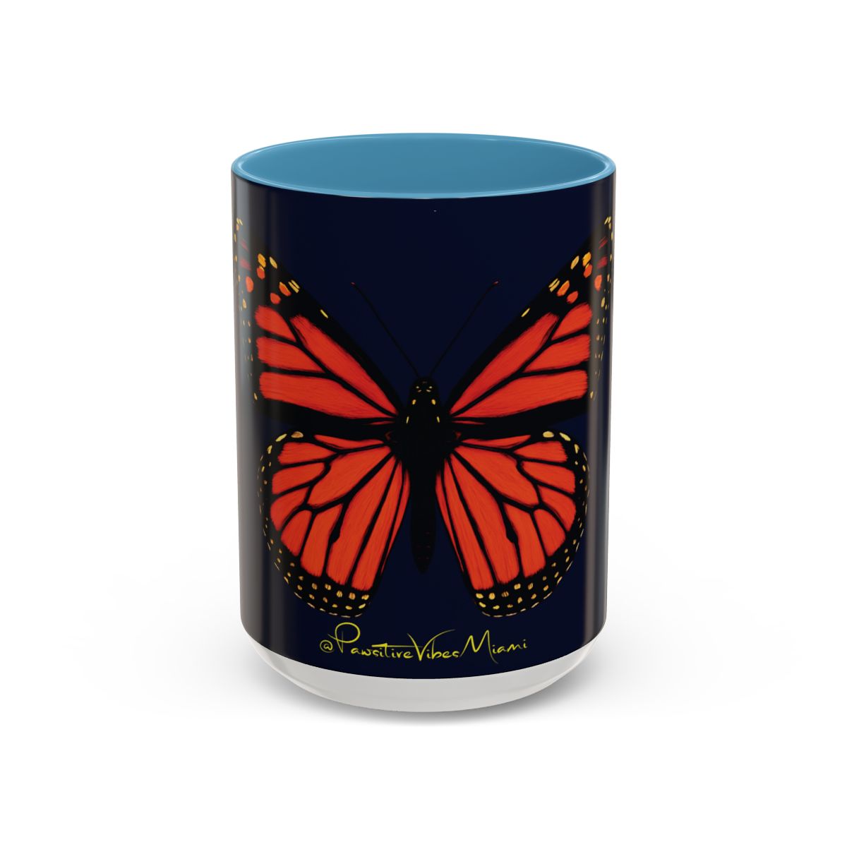 “Glossy black mug showing monarch butterfly glowing in warm tones.”