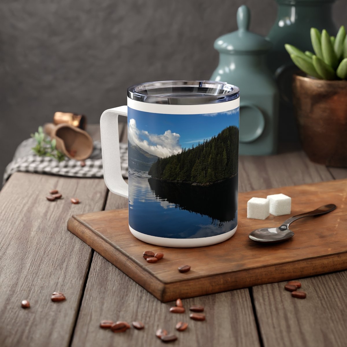 “Peaceful Alaska reflection scene on insulated mug showing deep greens and glacier blues.”