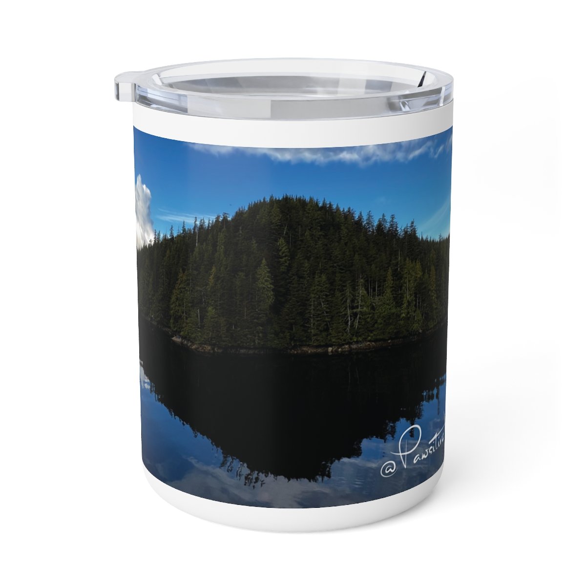 “Close‑up of insulated mug featuring sacred Alaska landscape with sky reflected on still lake.”