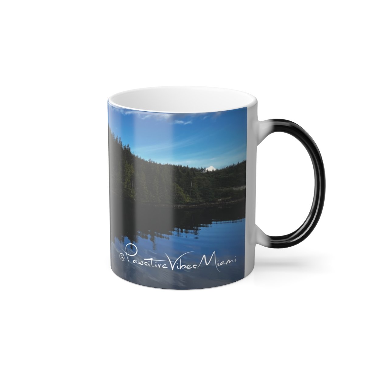 “Warmth‑activated mug revealing a tranquil Alaska island and its soft water reflection.”