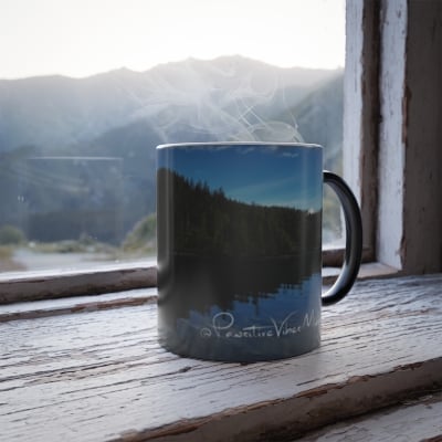“Close‑up of heat‑reveal mug showing an Alaska landscape slowly appearing in soft tones.”