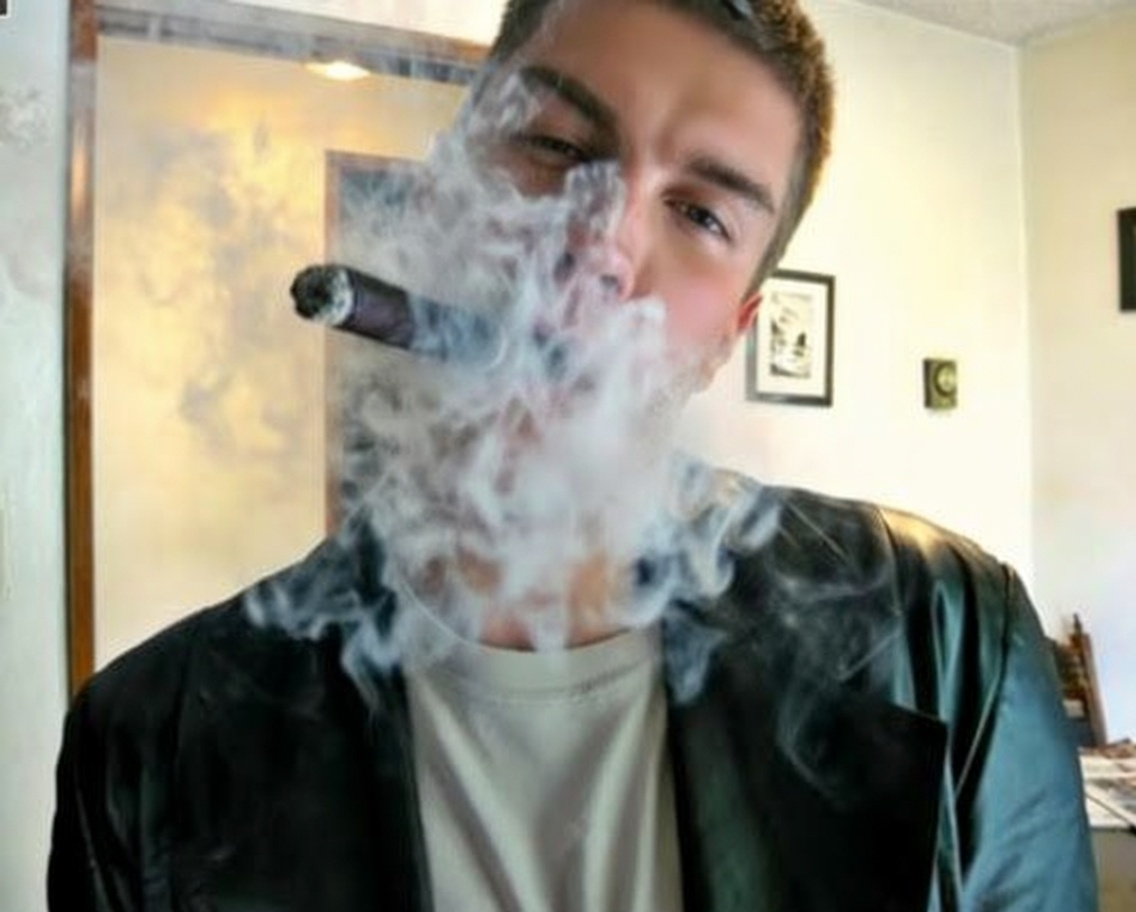 Oregonleatherboy wearing black leather blazer smoking long cigar blowing thick smoke
