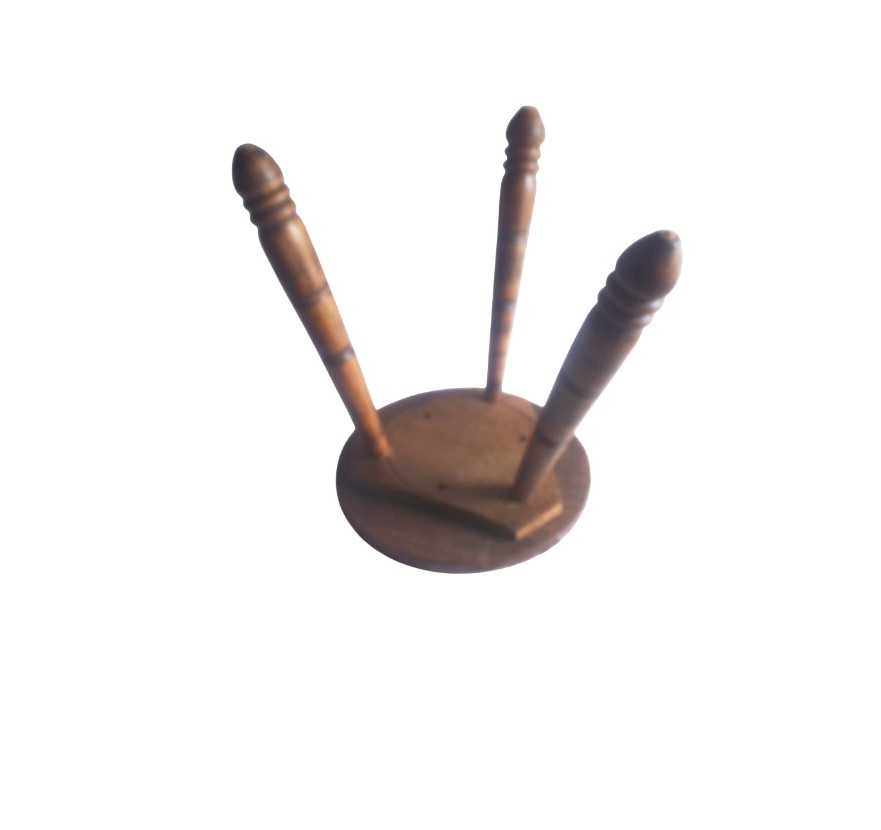 Tripod Stool handcrafted from wood, round seat with three spindle legs.