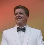 The author in a white dinner jacket and black tie