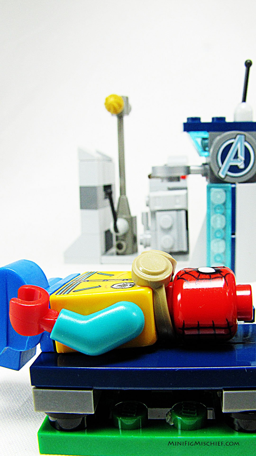 lego figure on a park bench taking a nap. in the back ground is the city skyline.