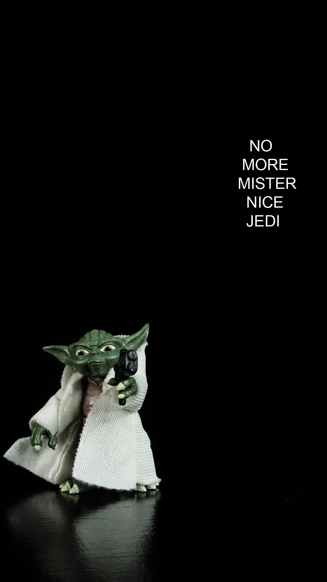 Yoda action figure on black back ground. he is pointing a blaster at the viewer. the text read "no more mr nice jedi"