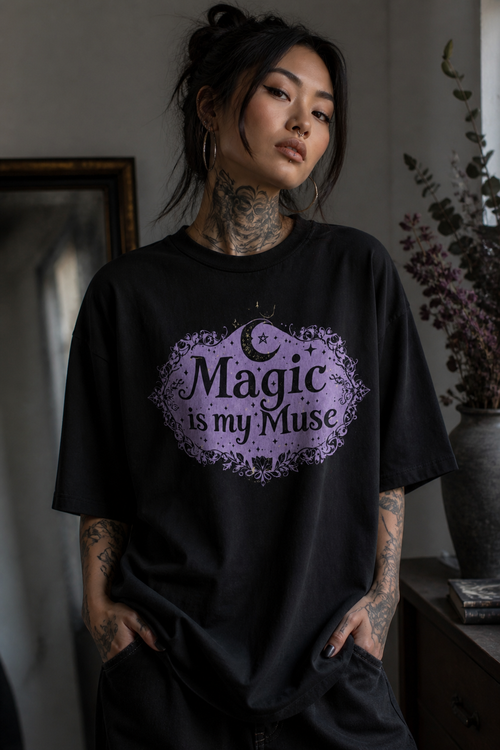 Black cotton t-shirt featuring a bold symbolic illustration of Magic is my Muse slogan by Catherine Gomersall