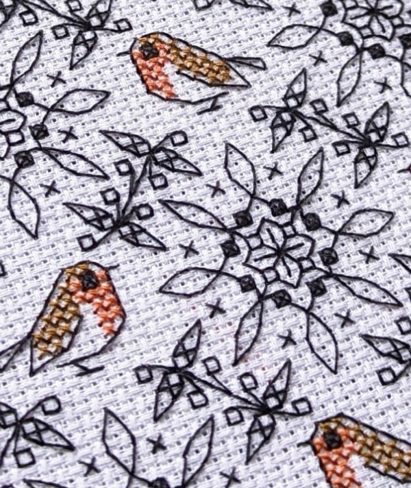 Close up of a robin blackwork embroidery pattern stitched on aida