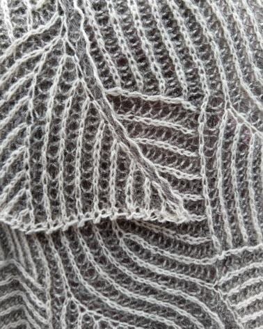 A close up of details of a grey and white Waterfall Shawl