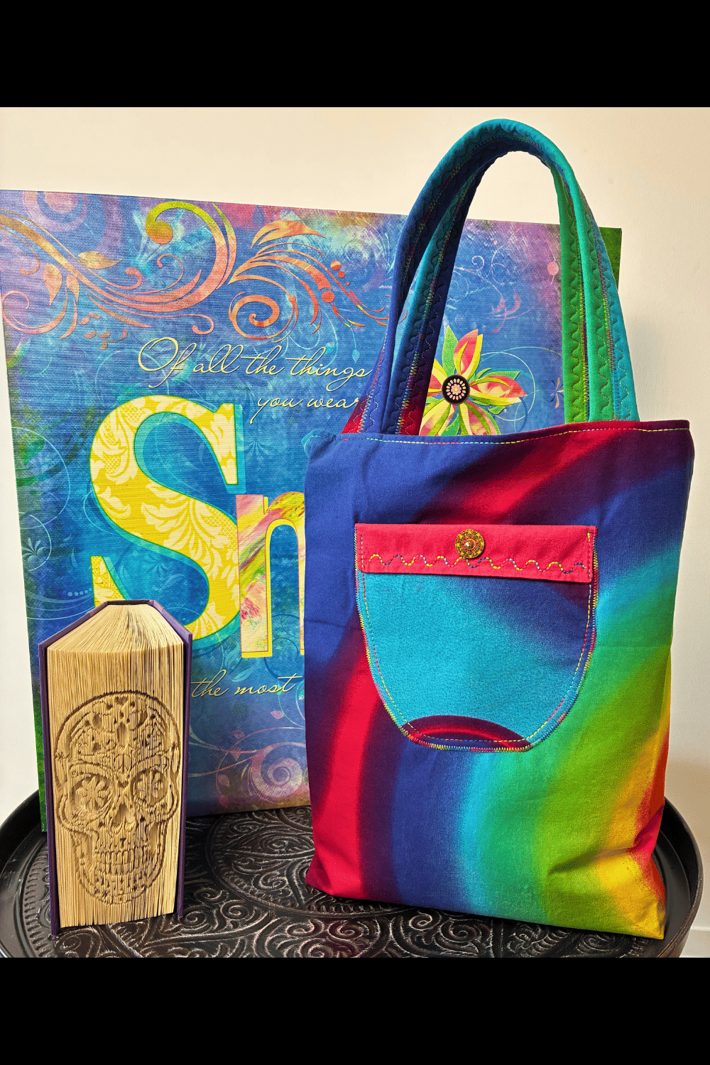 Front view of the handmade rainbow tote bag displaying the oversized contrast pocket, decorative stitching, and vibrant rainbow colour transitions.