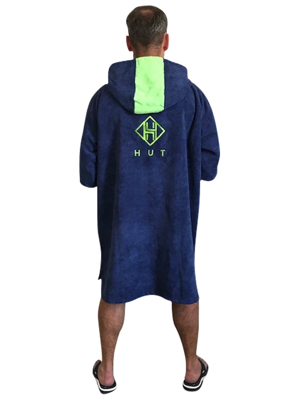 Person wearing a dark blue towel poncho facing away
