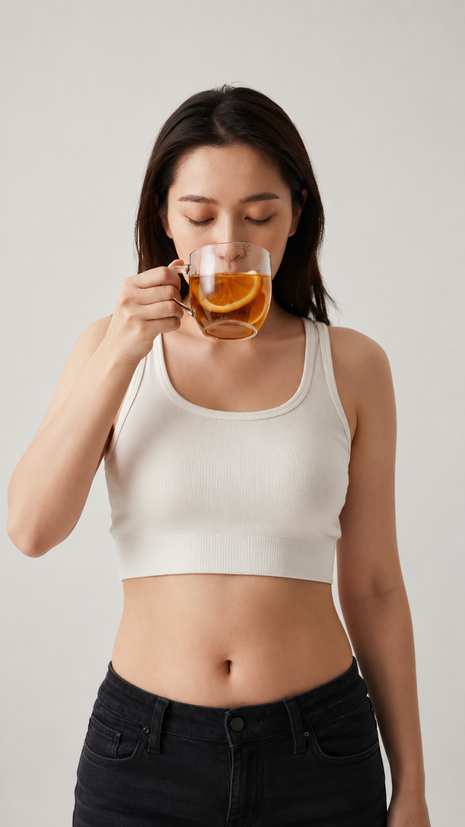 Woman drinking peppermint tea for trapped wind and bloating relief