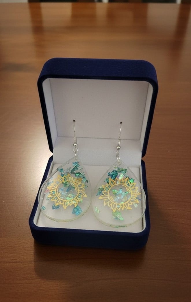 Celestial sun resin drop earrings with iridescent flakes presented in navy jewellery box