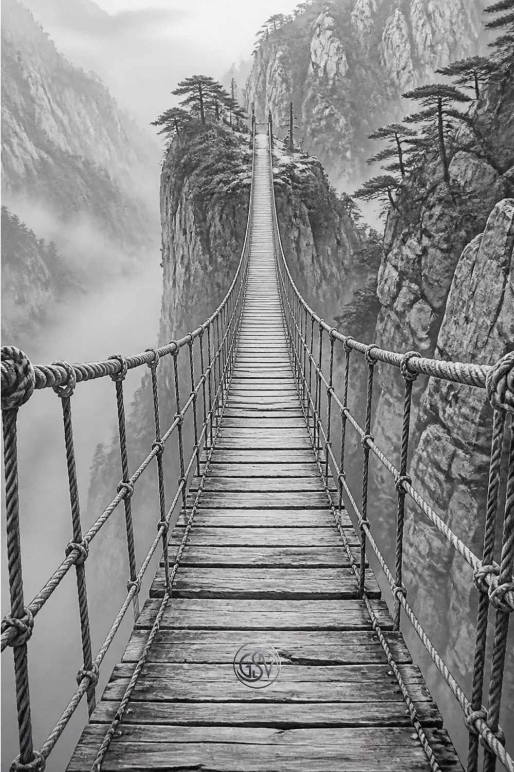 Grayscale coloring page of a suspension rope bridge crossing a misty mountain canyon
