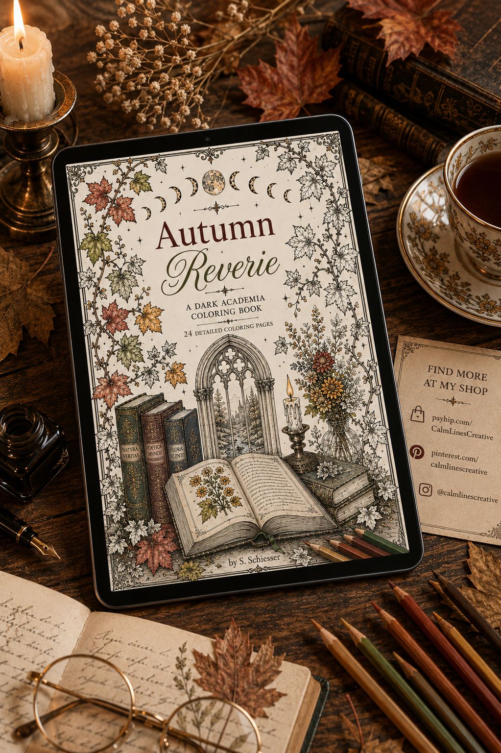Autumn Reverie coloring book cover on tablet, dark academia flatlay with tea, candle and autumn leaves