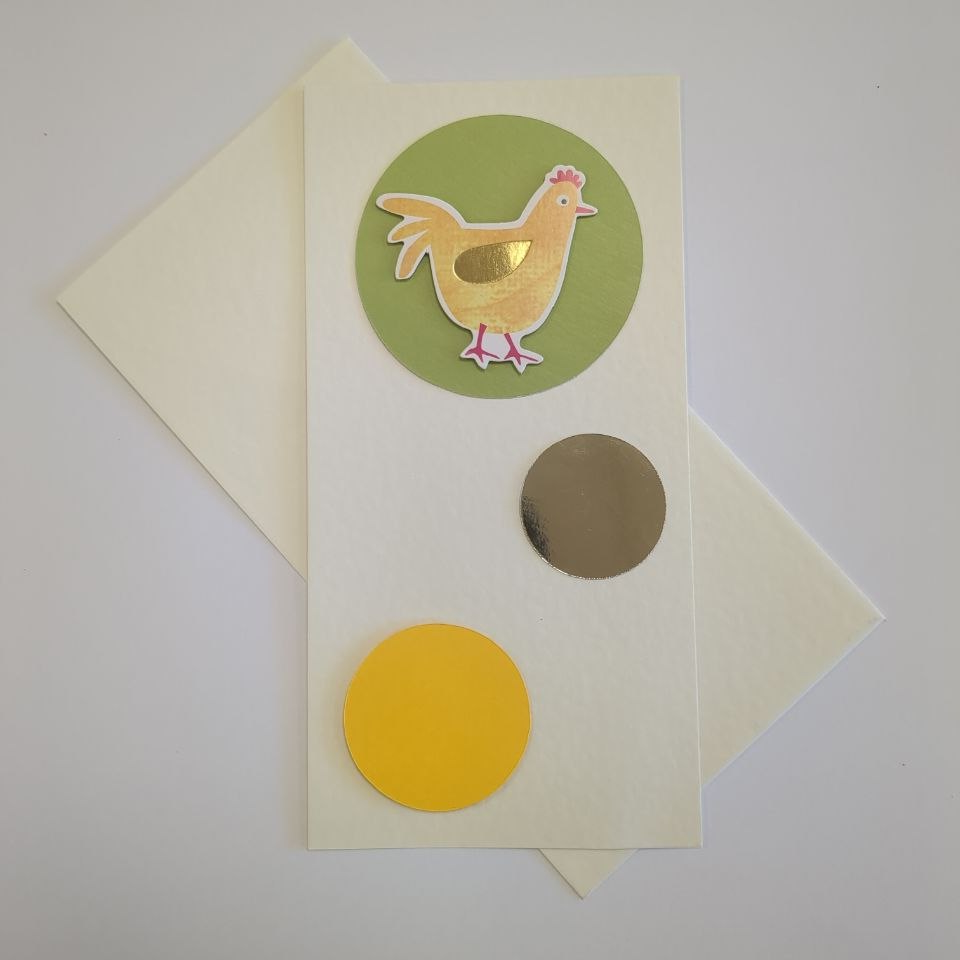 A tall portrait card in cream with a matching envelope. Three circles in different colours and sizes bubble up the card. The bottom one is medium and yellow. The middle one is smaller and made of gold mirror card. The top one is green and contains a motif