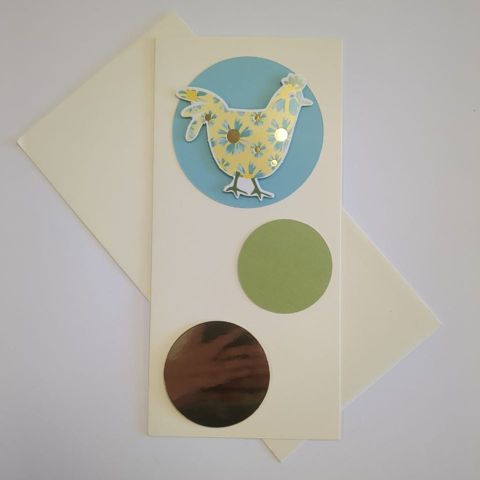 A tall portrait card in cream with a matching cream envelope. Three circles of different sizes and colours bubble up the card. The bottom one is medium and made of gold mirror card. The middle one is green and smaller. The top one is turquoise blue and ha