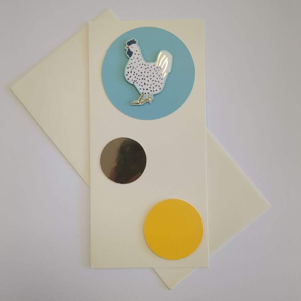 A tall portrait card in cream with a matching cream envelope. Three circles of different colours and sizes bubble up the card. The bottom one is yellow and medium. The middle one is made of gold mirror card and smaller. The top one is turquoise blue and h