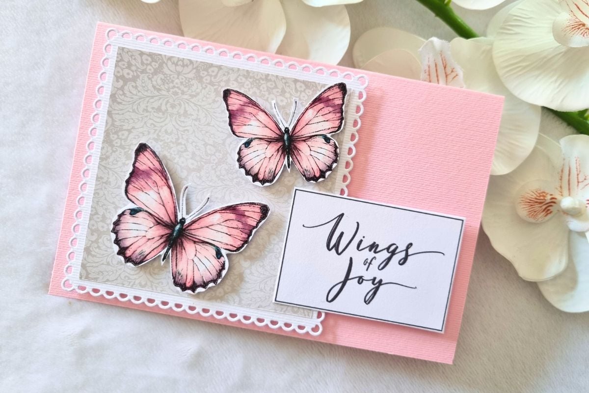 Pink handmade greeting card with two butterflies and WINGS OF JOY sentiment