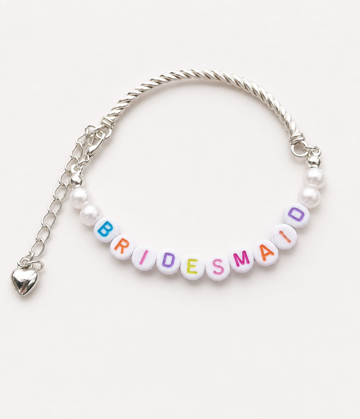 Handmade bridesmaid proposal charm bracelet featuring a silver twisted wire bangle, white pearls, rainbow BRIDESMAID letter beads, and a dangling silver heart charm.
