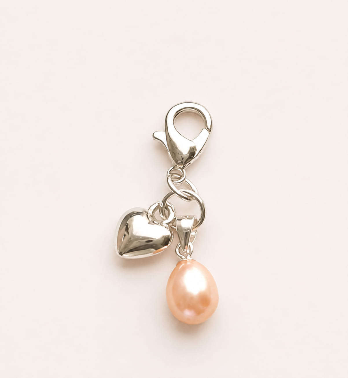 Handmade 925 sterling silver bridal bouquet memory charm featuring a dangling peach freshwater pearl and a polished silver heart charm