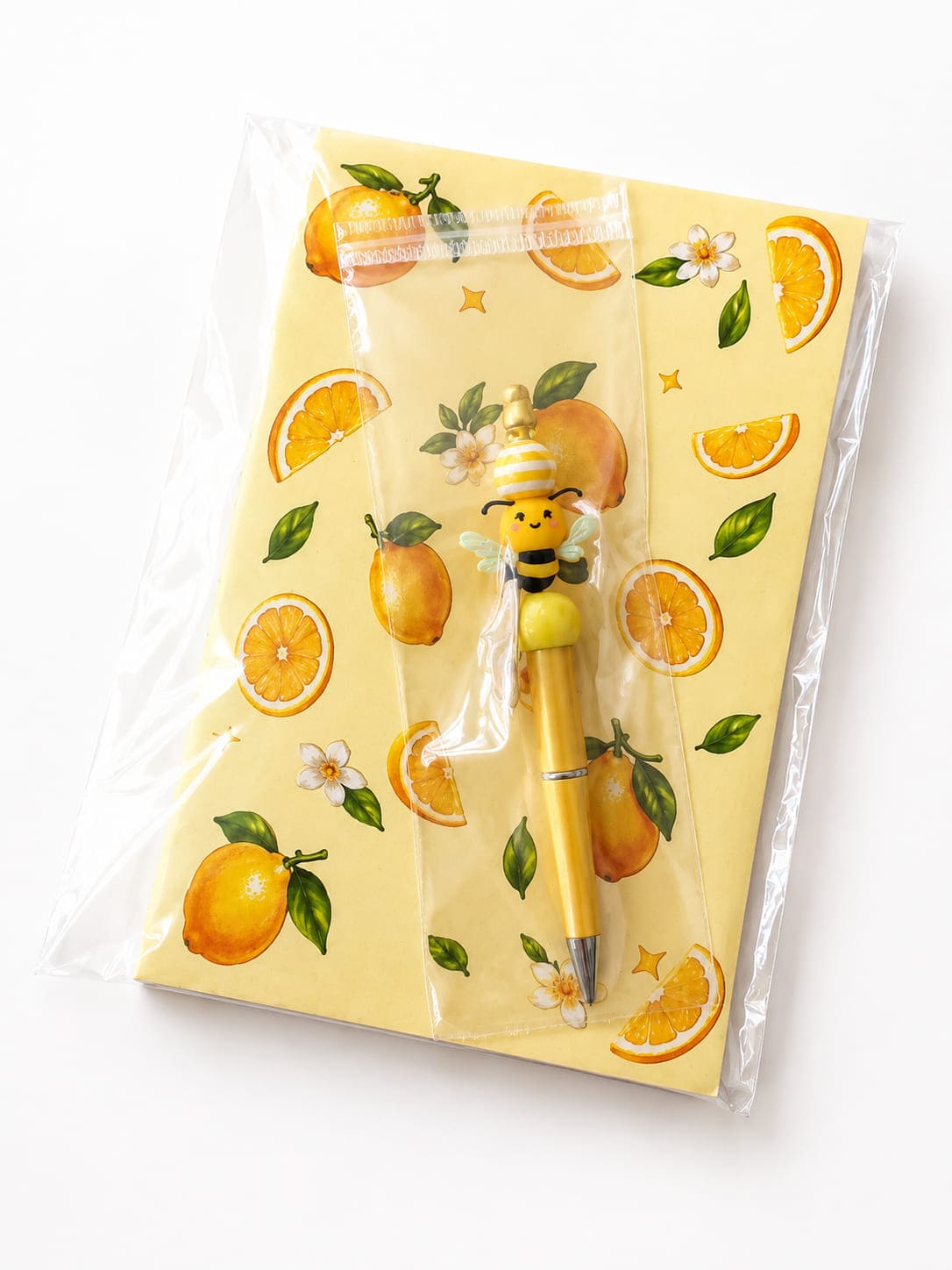 Lemon notebook and handmade bumblebee pen gift set packaged in a clear protective sleeve