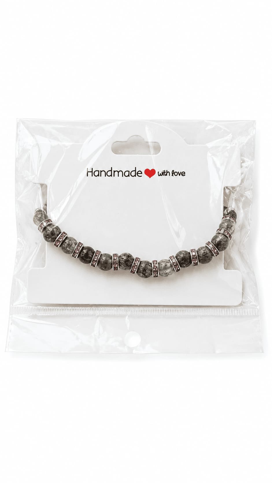 Grey and pink butterfly beaded bracelet presented on a Handmade with Love jewellery card