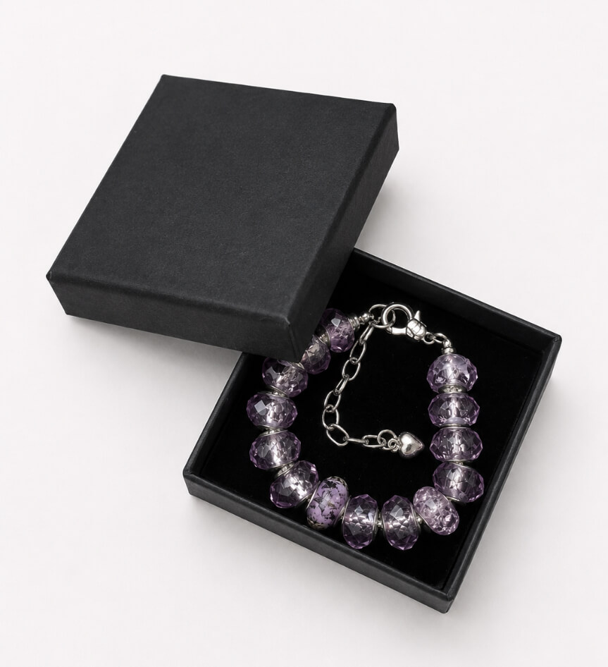 Purple faceted glass bead bracelet presented in a black jewellery gift box