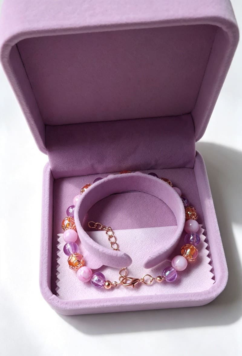 Handmade Violetta pastel bridal gemstone bracelet from Sparkling Resin Delights displayed inside an elegant open lilac velvet gift box on a white backdrop.