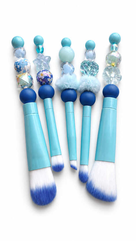 Five luxury bridal makeup brushes handcrafted with turquoise handles, blue floral beads, and crystal accents.