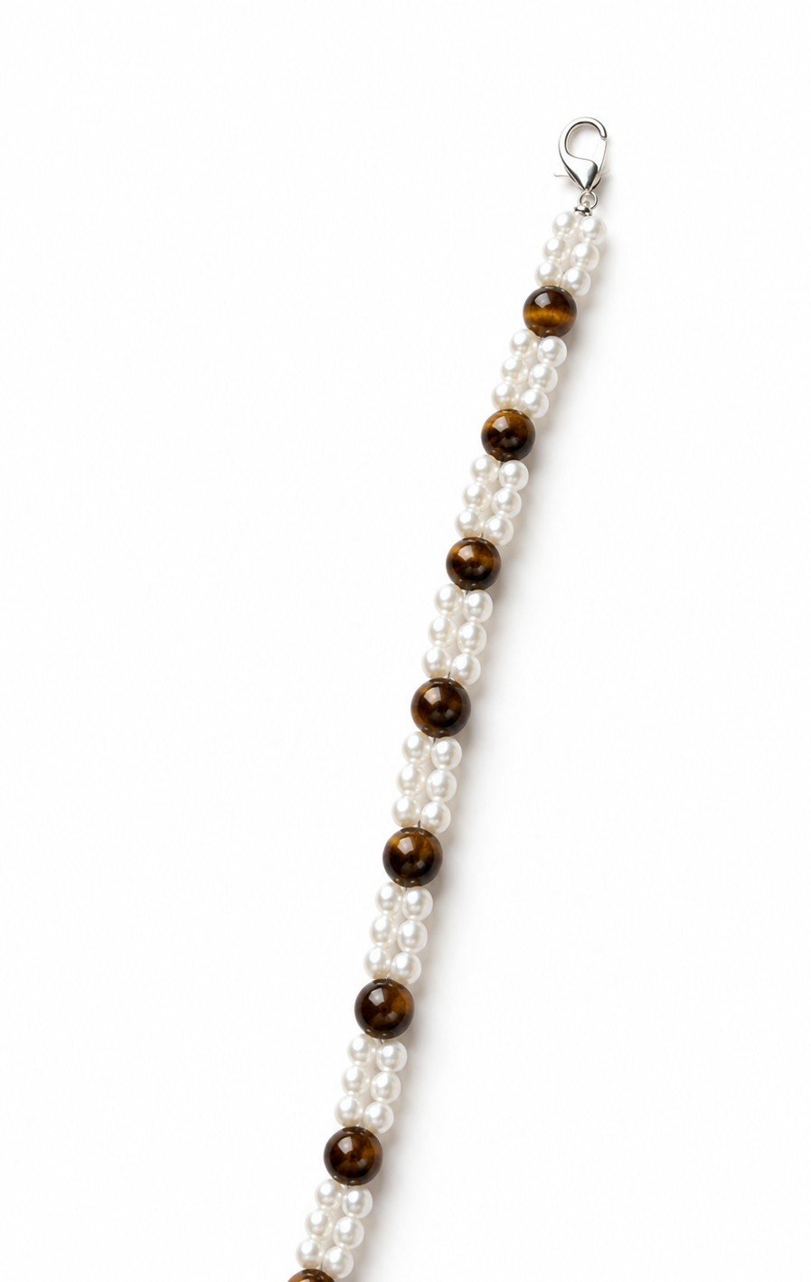 Vertical view of handmade tiger's eye and faux pearl bracelet with silver clasp