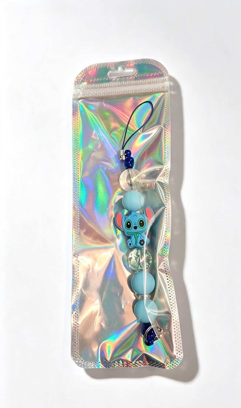 Handmade blue Stitch beaded phone charm presented inside an iridescent holographic gift pouch