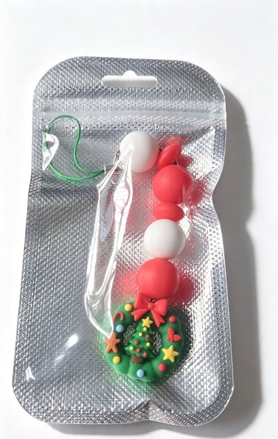 Handmade Christmas wreath beaded ornament presented in resealable silver gift packaging