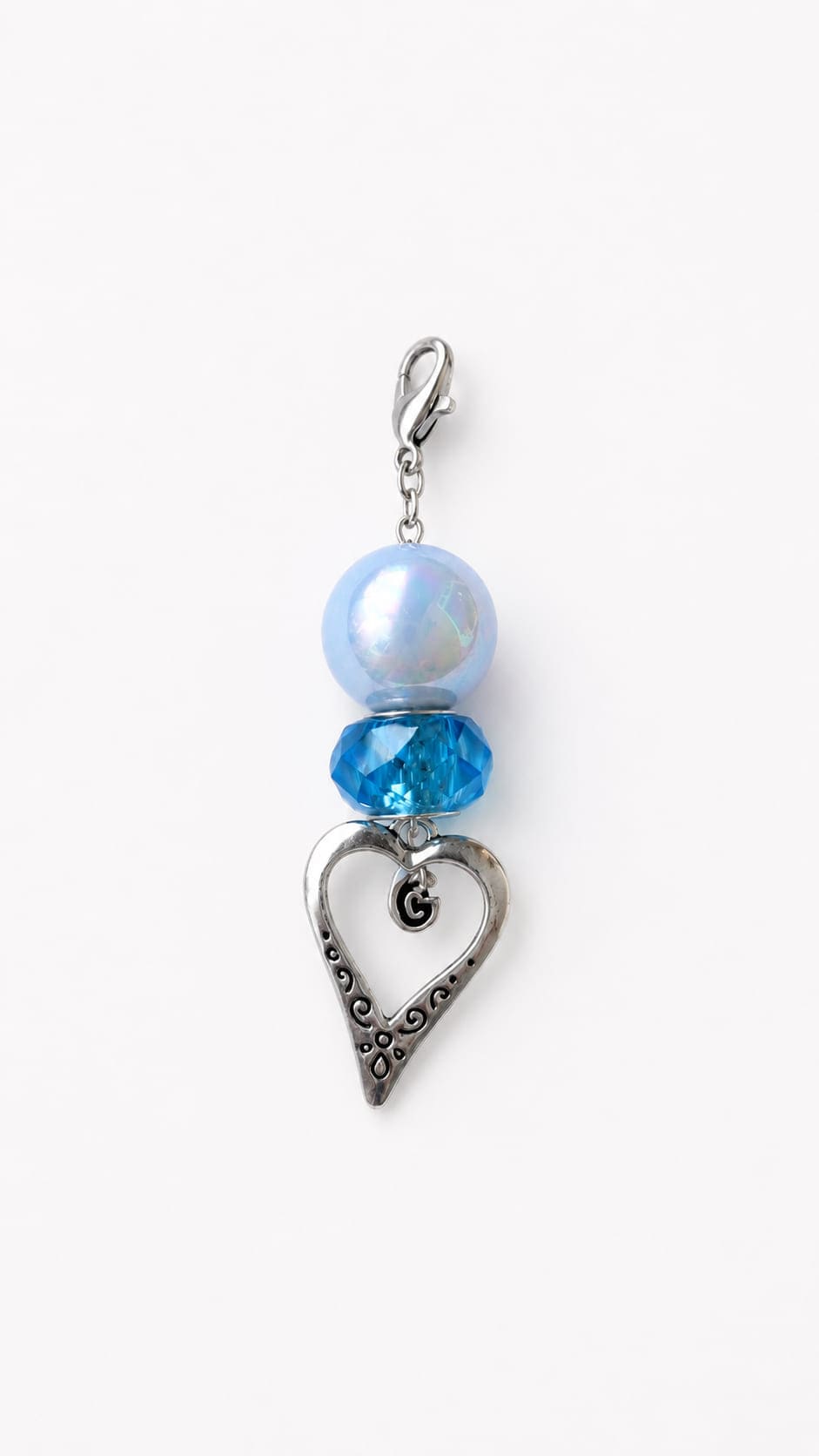 Handmade Something Blue wedding keepsake clip charm featuring a large, iridescent pastel periwinkle pearl bead paired with a vibrant, translucent faceted turquoise crystal bicone bead. The base is finished with a dangling zinc alloy ancient silver filigre
