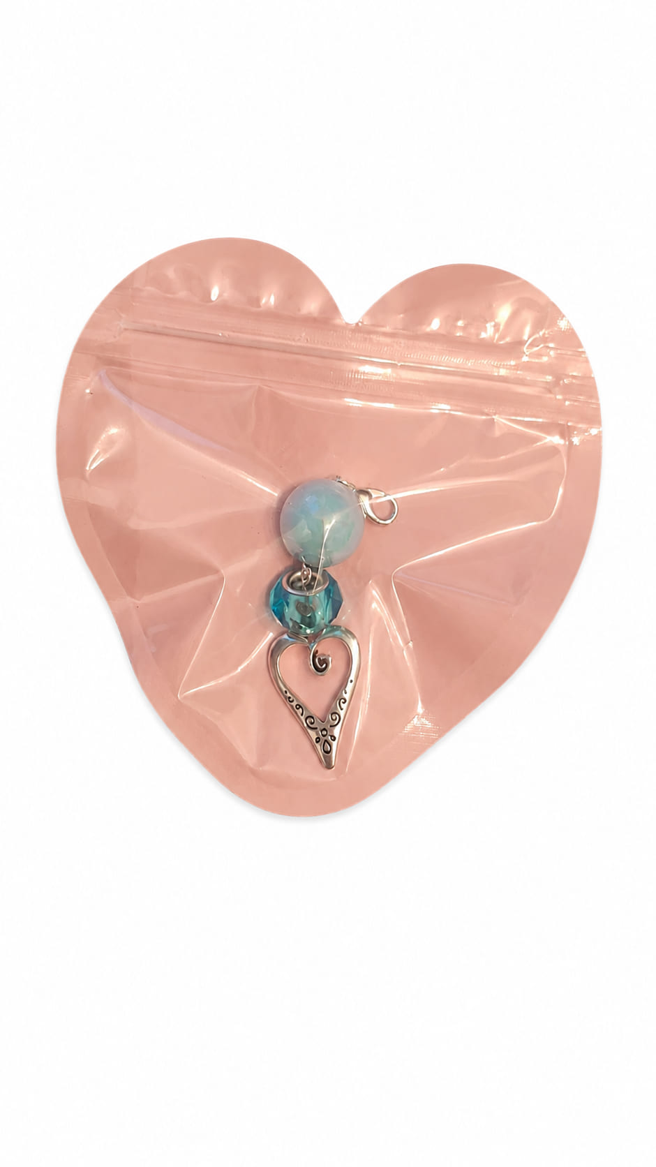 Individual handmade Something Blue bridal clip charms by Sparkling Resin Delights, each safely sealed flat inside its own signature pink heart-shaped boutique packaging pouch with a clear front window showcasing the unique beaded layout and antique silver