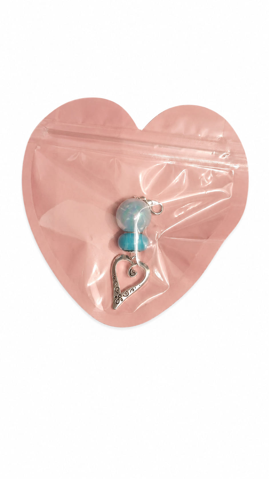 Individual handmade Something Blue bridal clip charms by Sparkling Resin Delights, each safely sealed flat inside its own signature pink heart-shaped boutique packaging pouch with a clear front window showcasing the unique beaded layout and antique silver