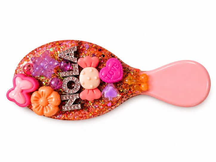 Personalised pink hairbrush hand-decorated in resin with glitter, colourful 3D charms and rhinestone-style name